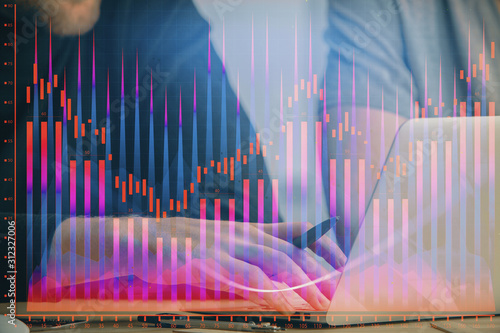 Forex graph with businessman typing on computer in office on background. Concept of analysis. Double exposure. © peshkova