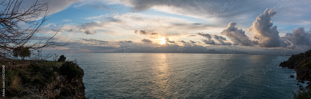 Beatiful panoromic seascape at sunset with dramatic clouds on mediterranean sea, panaroma  of sunset