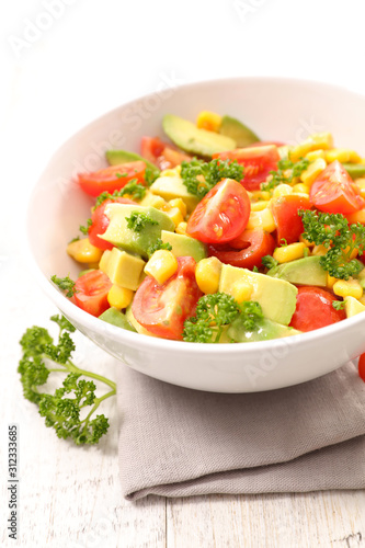 bowl of tomato, avocado and corn salad