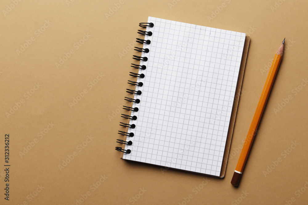 notebook and pencil on a colored background. notebook and pencil on a colored background.
