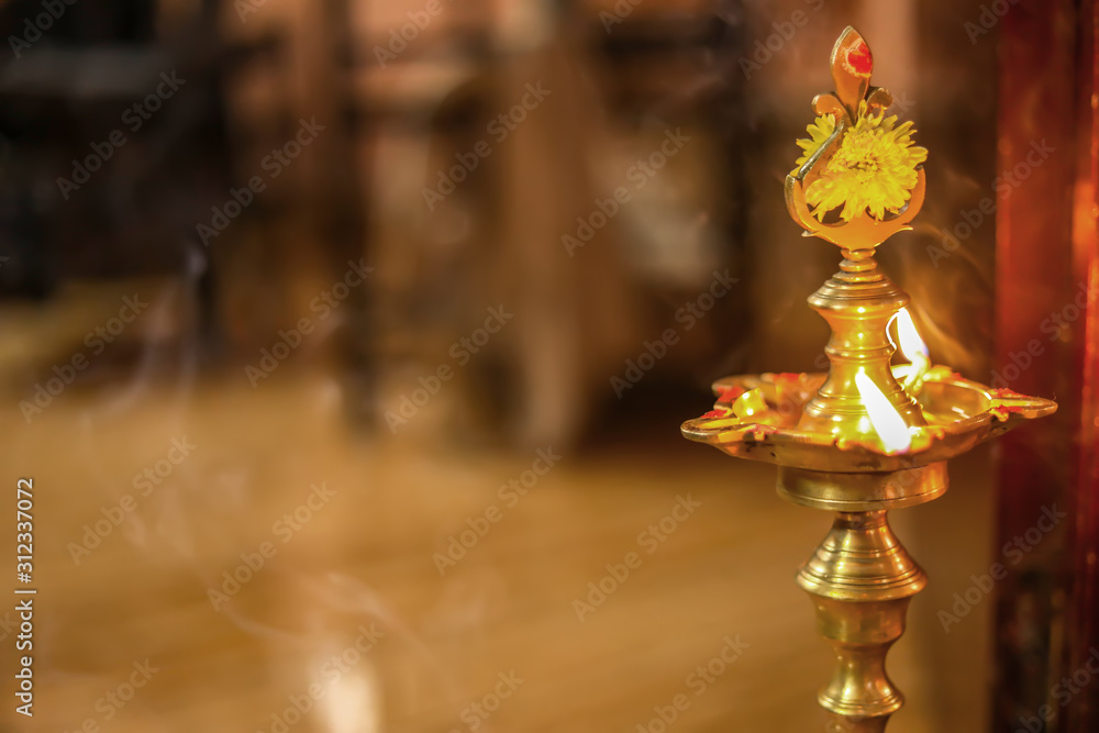 Traditional south indian brass oil lamp 'Nilavilakku '. During events like  housewarming, This picture is taken during a festival day celebration in  house Stock Photo | Adobe Stock