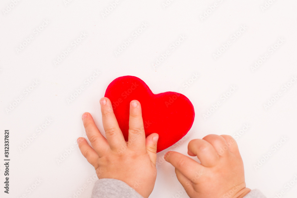 Fototapeta premium heart in babys hand isolated on white background, copy space