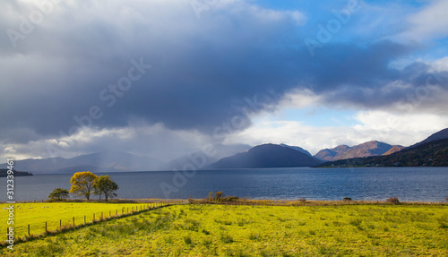 Trees and dark clouds at Loch Linnhe, Scottish Highlands photo