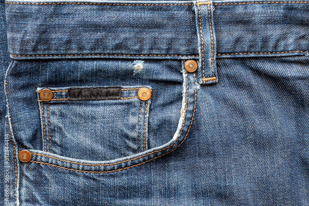 details of worn blue denim jeans pockets, worn edges details of worn blue denim jeans pockets, worn edges