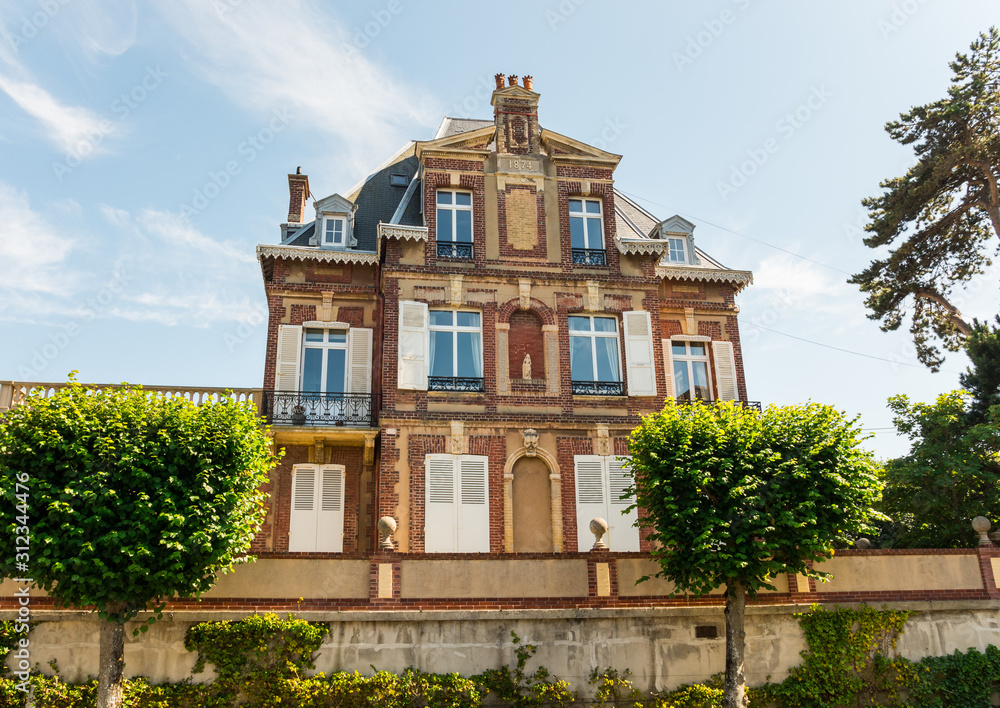 Beautiful typical manor in Cabourg, Normandy, France. Sunny summer day