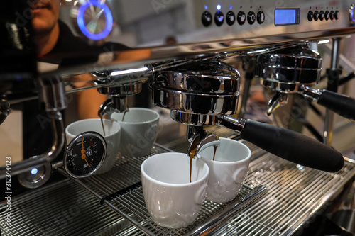  Barista making coffee at coffee machine at Gastrofood - Trade Fair for Food and Drinks for Catering in Cracow. Poland