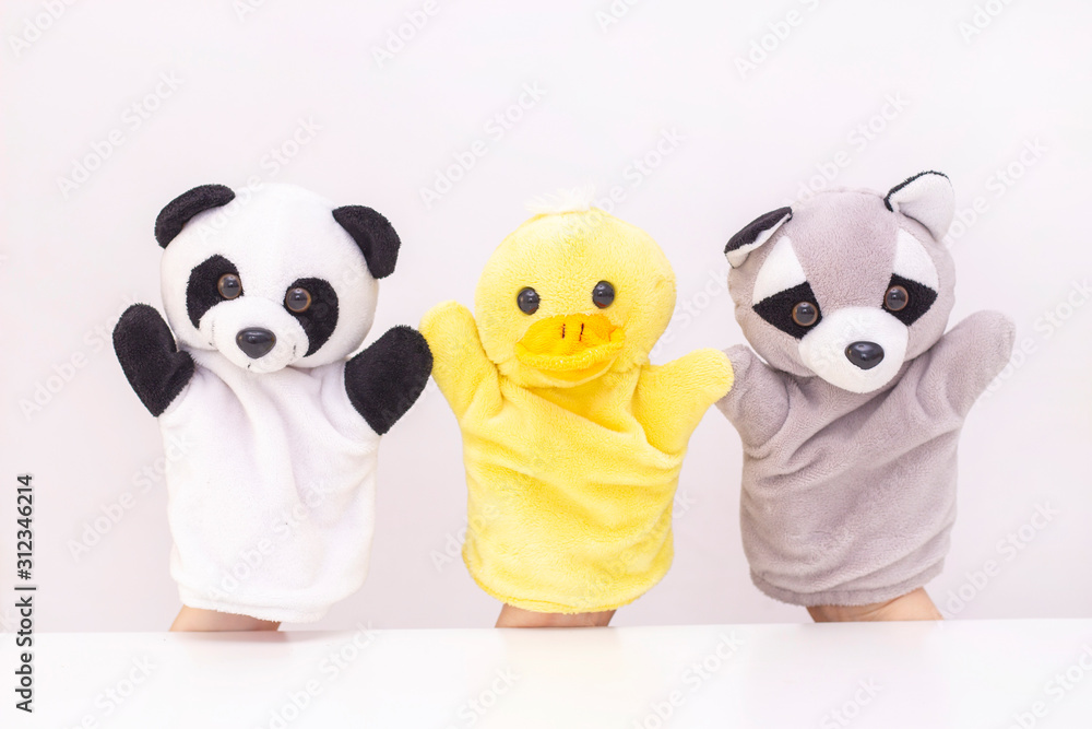 puppet theater on a white background. friendly animals hold hands. The concept of playing with children, friendship, family, entertainment. Nanny entertains children. copyspace puppet theater on a white background. friendly animals hold hands. The concept of playing with children, friendship, family, entertainment. Nanny entertains children. copyspace