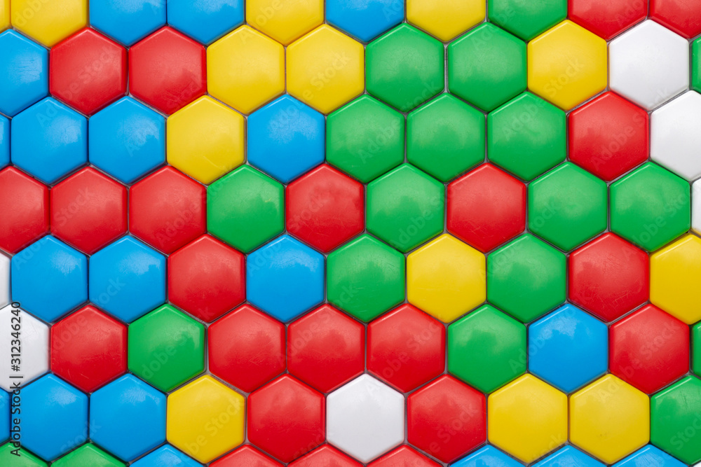 background texture of mosaic, plastic in the shape of hexagons. multicolored abstract photo. red blue yellow red white colors. child Game background texture of mosaic, plastic in the shape of hexagons. multicolored abstract photo. red blue yellow red white colors. child Game
