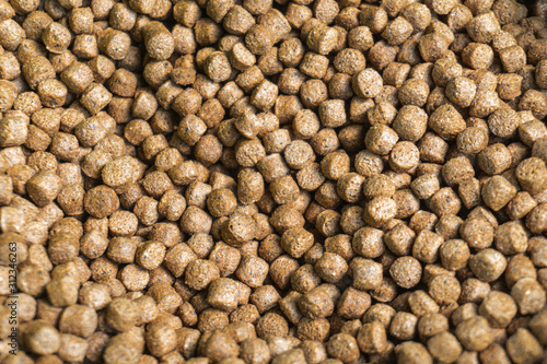 Close up brown small pellets feed the fish