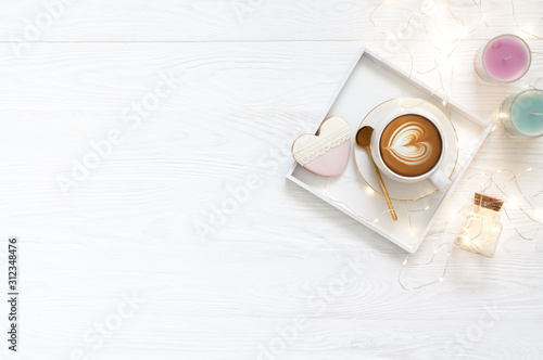 Coffee mug, candles and gingerbread in the form of a heart. White background.
