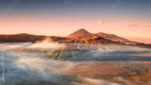 Colourful sunrise at the Mount Bromo, King Kong Hill Viewpoint. Wideangle panorama shot of amazing daybreak in Gunung Bromo active volcano in Java, Indonesia. Morning mist inversion photography. © stanic8