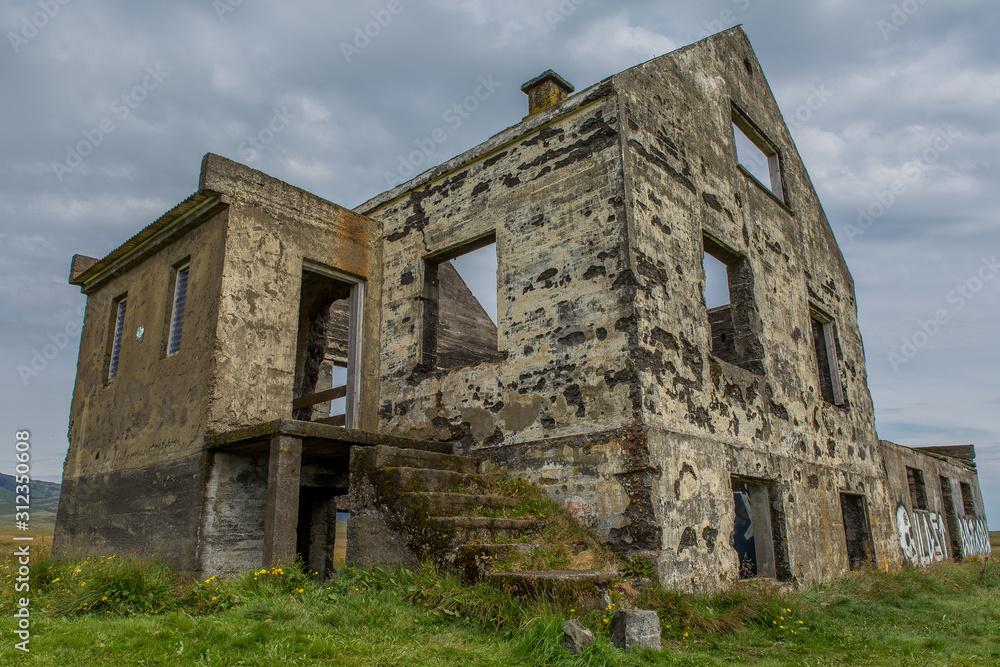 View of an old abandoned destroyed house. Ladder overgrown with green grass View of an old abandoned destroyed house. Ladder overgrown with green grass
