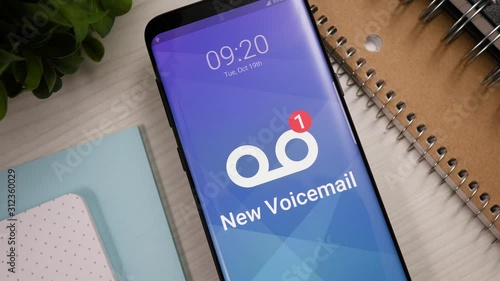 Smartphone showing a new voicemail notification banner appearing on the lock screen. Mobile phone alerting the user.