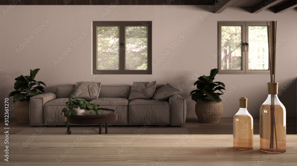 Wooden table top or shelf with aromatic sticks bottles over blurred country living room with sofa, carpet and coffee table, potted plants, white architecture interior design Wooden table top or shelf with aromatic sticks bottles over blurred country living room with sofa, carpet and coffee table, potted plants, white architecture interior design