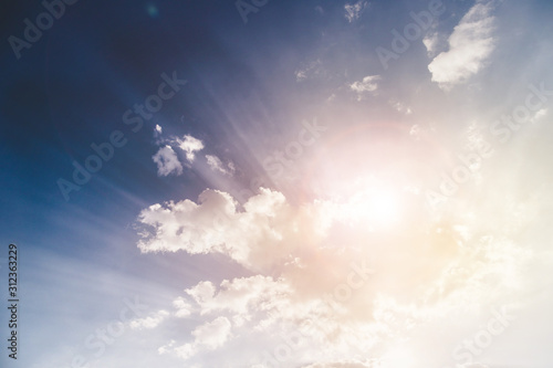 Freedom and spirituality concept. Sunbeams and clouds on a blue sky photo