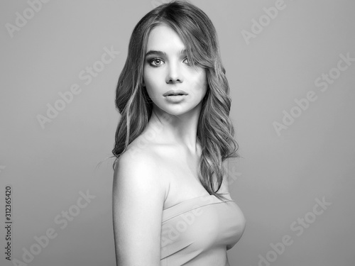 Beautiful young woman with curly hair. model girl
