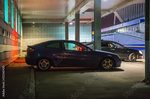 Cars at night in a parking lot © Yuri Bizgaimer