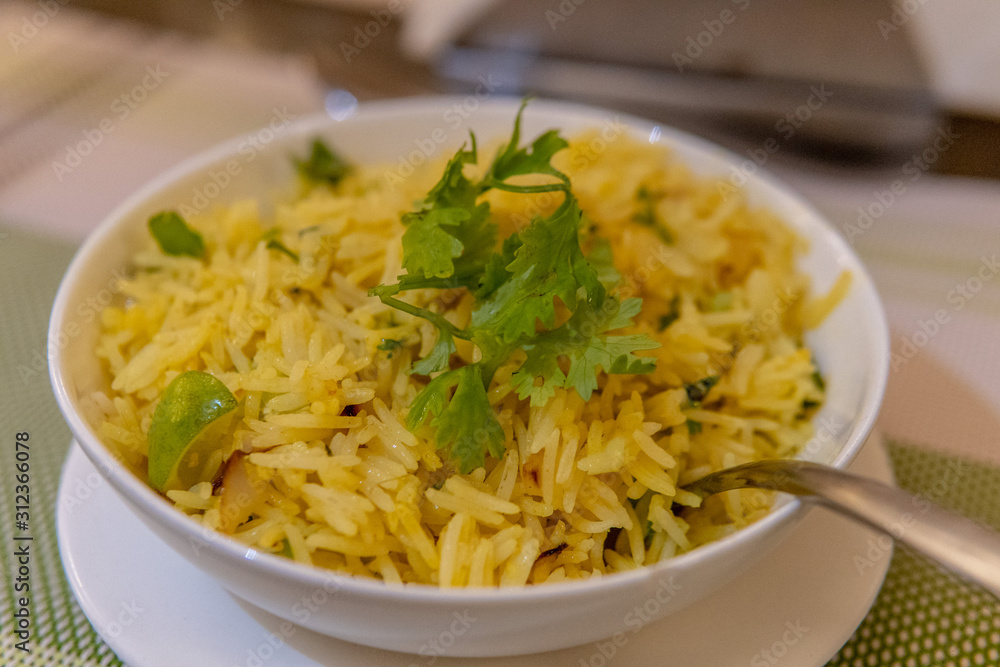 Yellow saffron rice with green garnish Yellow saffron rice with green garnish