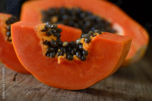 papaya sliced on wood background
