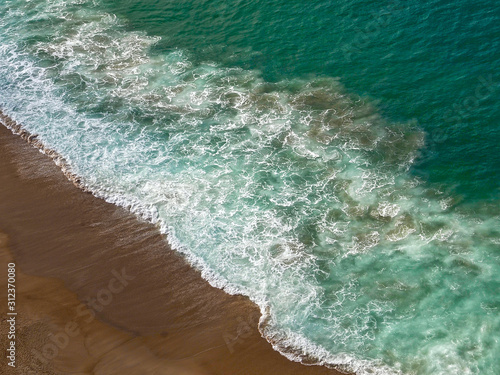 Wonderful aerial view of beach and waves at Nazare in Portugal