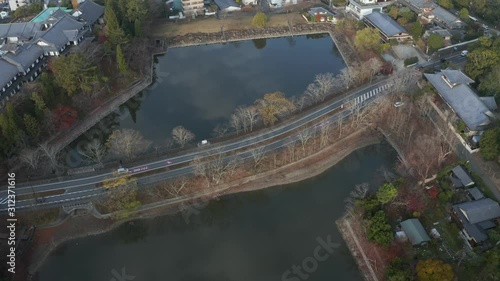 Nara Moat, Aerial view of traffic on road passing city park on early autumn morning photo