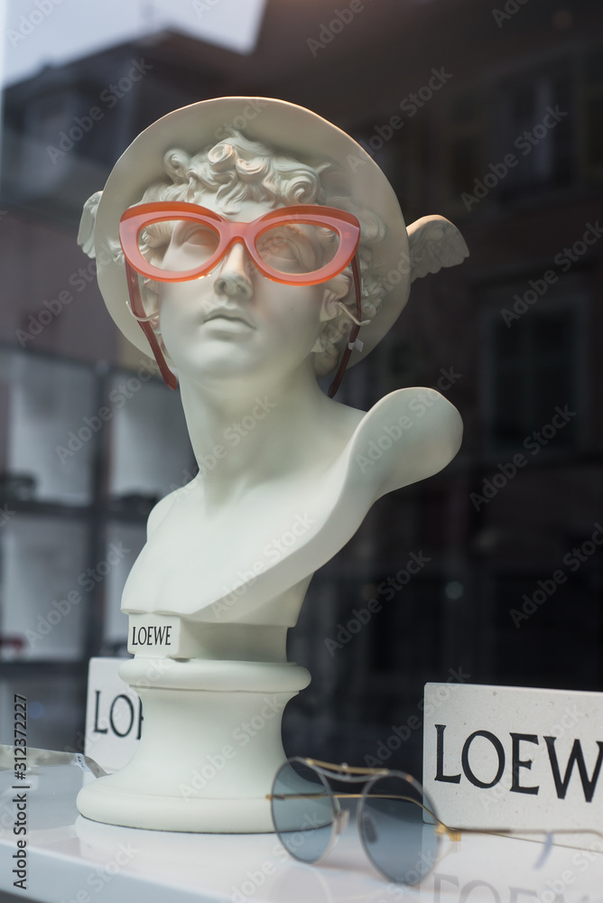 Mulhouse - France - 29 December 2019 - Closeup of eyeglasses presentaion on  statue by Loewe in optician store showroom Photos | Adobe Stock