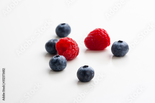 blueberries and raspberries on the white