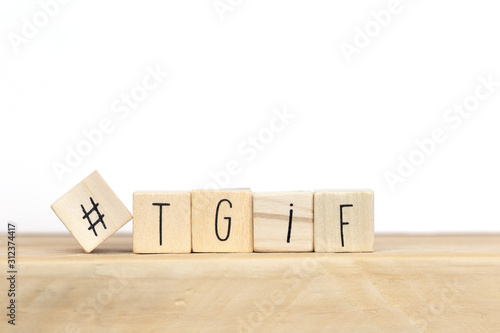 Wooden cubes with Hashtag and the word tgif, meaning Thank god its Friday, social media concept background photo