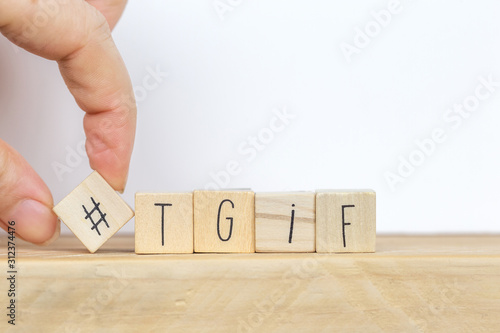 Wooden cubes with Hashtag and the word tgif, meaning Thank god its Friday, social media concept background
