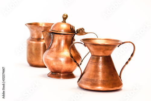 Series of little decorative copper artisan objects isolated on white background - photography