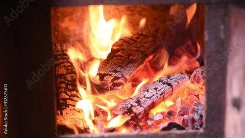 Fire in the classic russian bathhouse furnace. Tipical village life