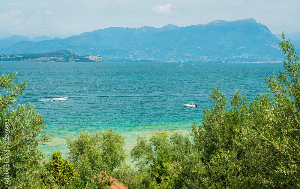 Jamaica Beach at Sirmione, on Lake Garda, renowed for its beautiful emerald water. Province of Brescia, Lombardy, Italy.