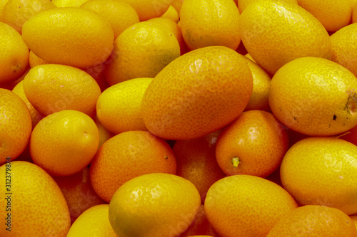 fresh orange citrus Kumquat fruit isolated on a black background