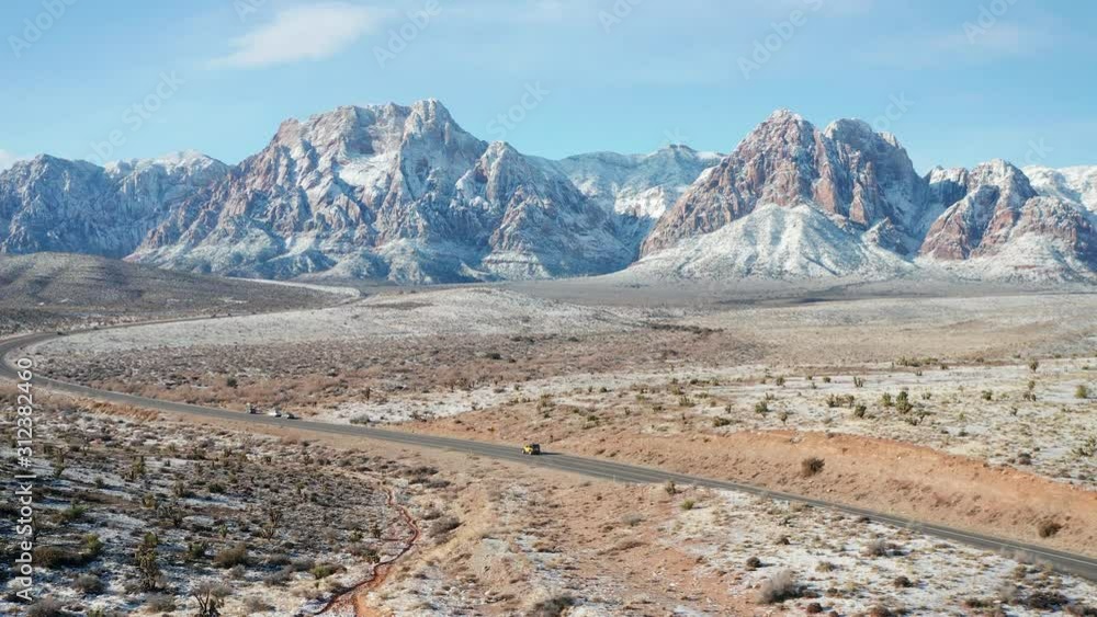 Aerial view of cars driving in snow desert mountain landscape in Red Rock Canyon Aerial view of cars driving in snow desert mountain landscape in Red Rock Canyon
