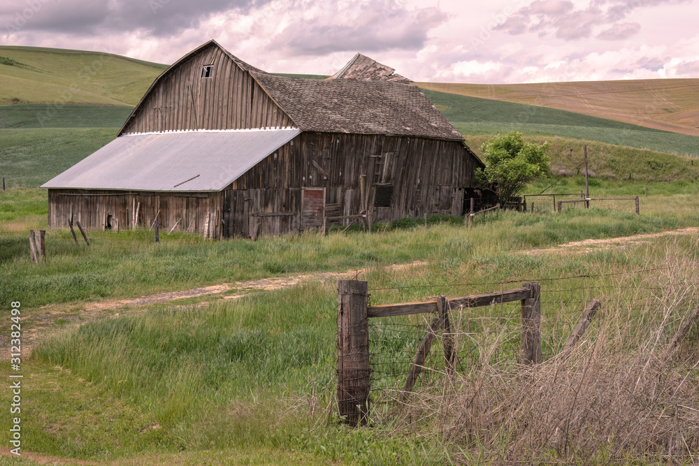 Old barn with a sunken roof, and a fence with barbed wire. Image taken in  the Palouse region of Washington state. Stock Photo | Adobe Stock