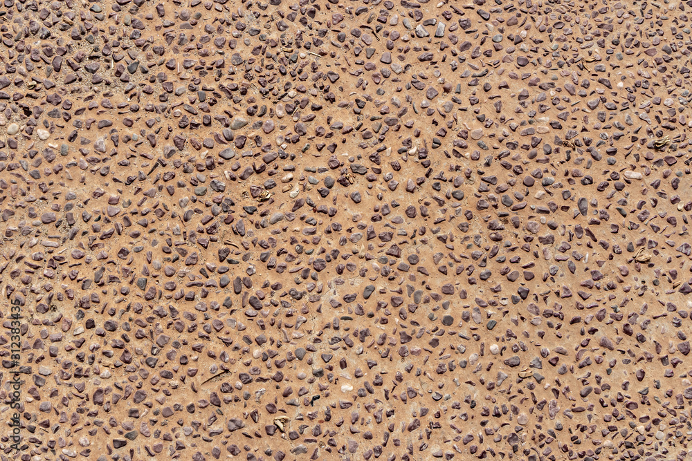 Beautiful texture of path of gray smooth stones on the orange background is in the park Beautiful texture of path of gray smooth stones on the orange background is in the park