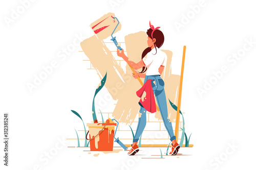 Female painting wall with roller beige colour