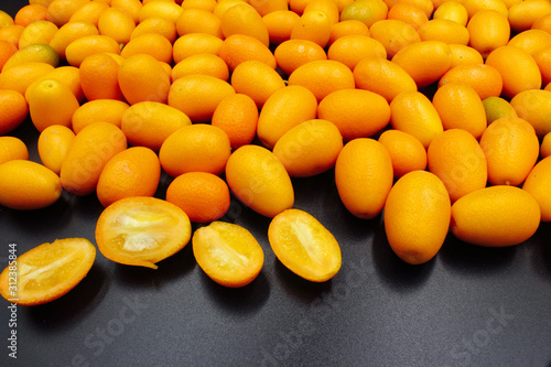 fresh orange citrus Kumquat fruit isolated on a black background photo