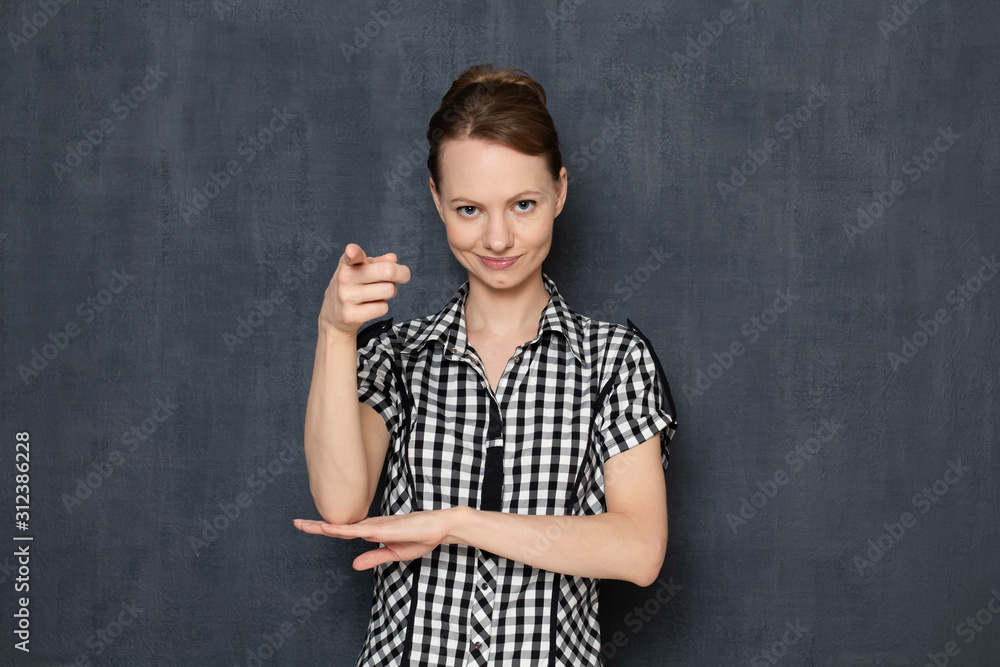 Portrait of happy girl smiling and pointing with finger at you Portrait of happy girl smiling and pointing with finger at you