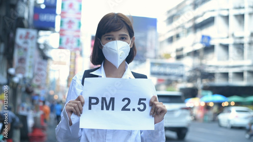 Concept of pollution prevention. The girl wearing a mask is holding a sign indicating the message. 4k Resolution.