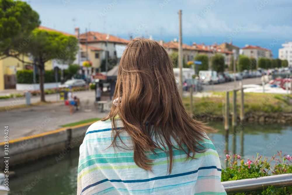 Woman enjoying the view in the resort harbor of a modern village sea port