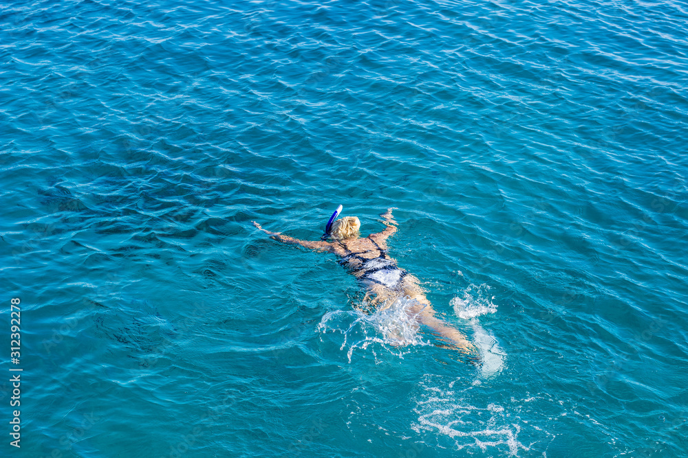 aerial view swimming girl in Red sea clear blue waters summer time vacation concept wallpaper banner with empty copy space for your text