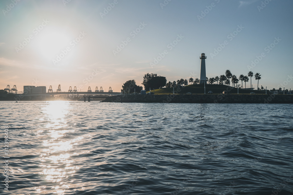 sunset behind a lighthouse in Los Angeles USA