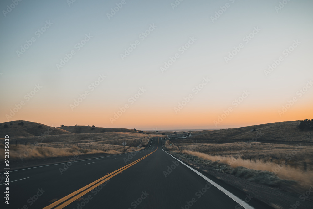 lonely road in California during the sunset