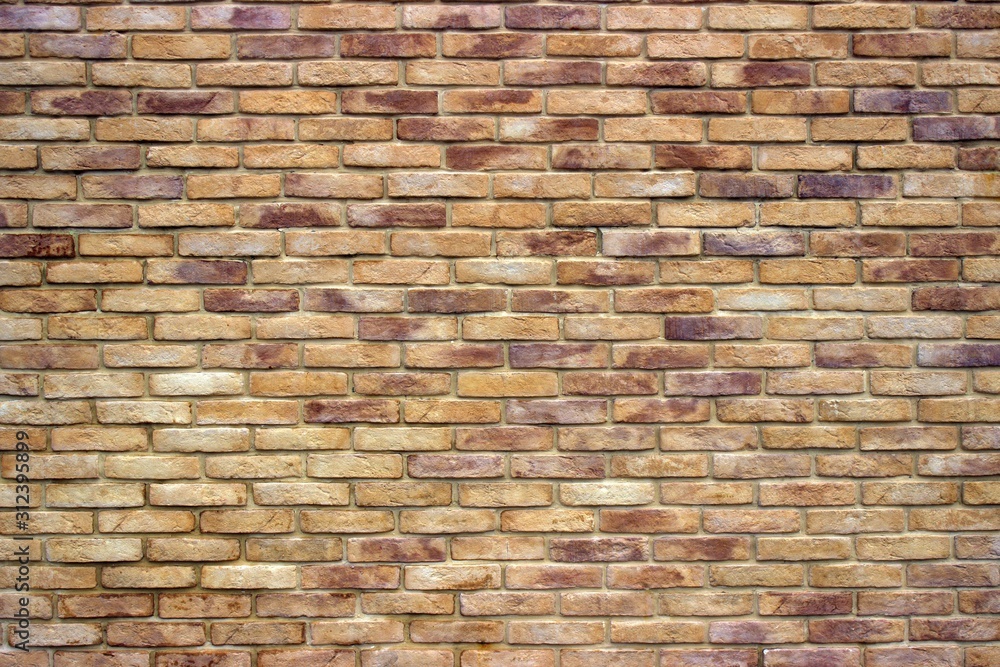 Fototapeta premium Brick wall of red-brown and light brown colors. Wide format. Retro style.