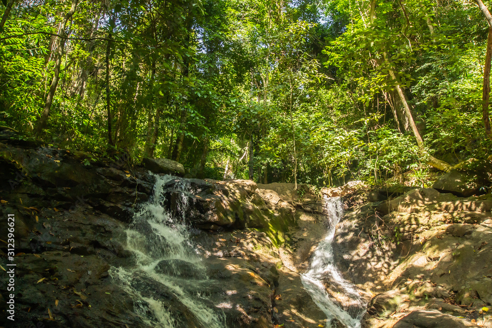 Kathu Waterfall in the tropical forest area In Asia, suitable for walks, nature walks and hiking, adventure photography Of the national park Phuket Thailand,Suitable for travel and leisure. Kathu Waterfall in the tropical forest area In Asia, suitable for walks, nature walks and hiking, adventure photography Of the national park Phuket Thailand,Suitable for travel and leisure.