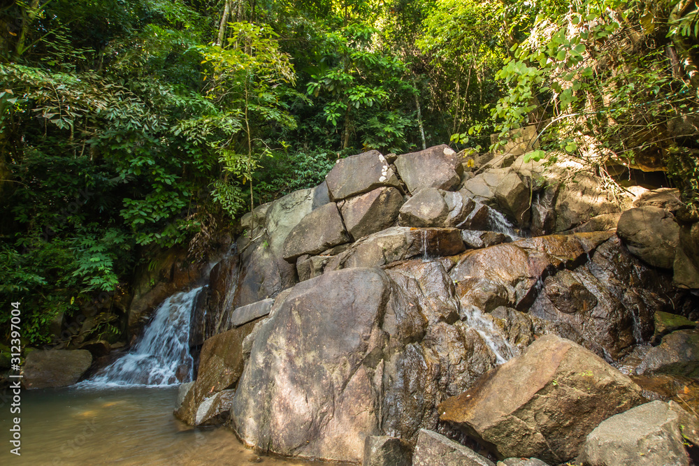 Kathu Waterfall in the tropical forest area In Asia, suitable for walks, nature walks and hiking, adventure photography Of the national park Phuket Thailand,Suitable for travel and leisure.