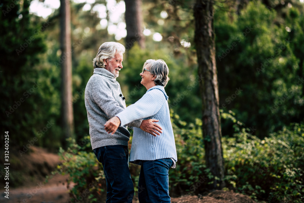 Senior couple in relationship and love hug together in outdoor leisure activity in the forest nature - old people forever together life with happiness Senior couple in relationship and love hug together in outdoor leisure activity in the forest nature - old people forever together life with happiness