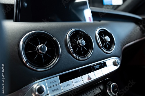Modern car air vents and air conditioner control panel. © Daniel Jędzura