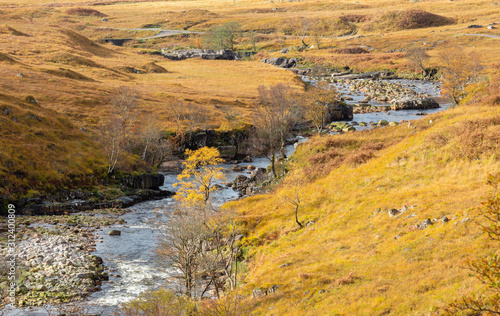 Autumn Colour surrounds river in Glen Etive near Glencoe Highlands Scotland